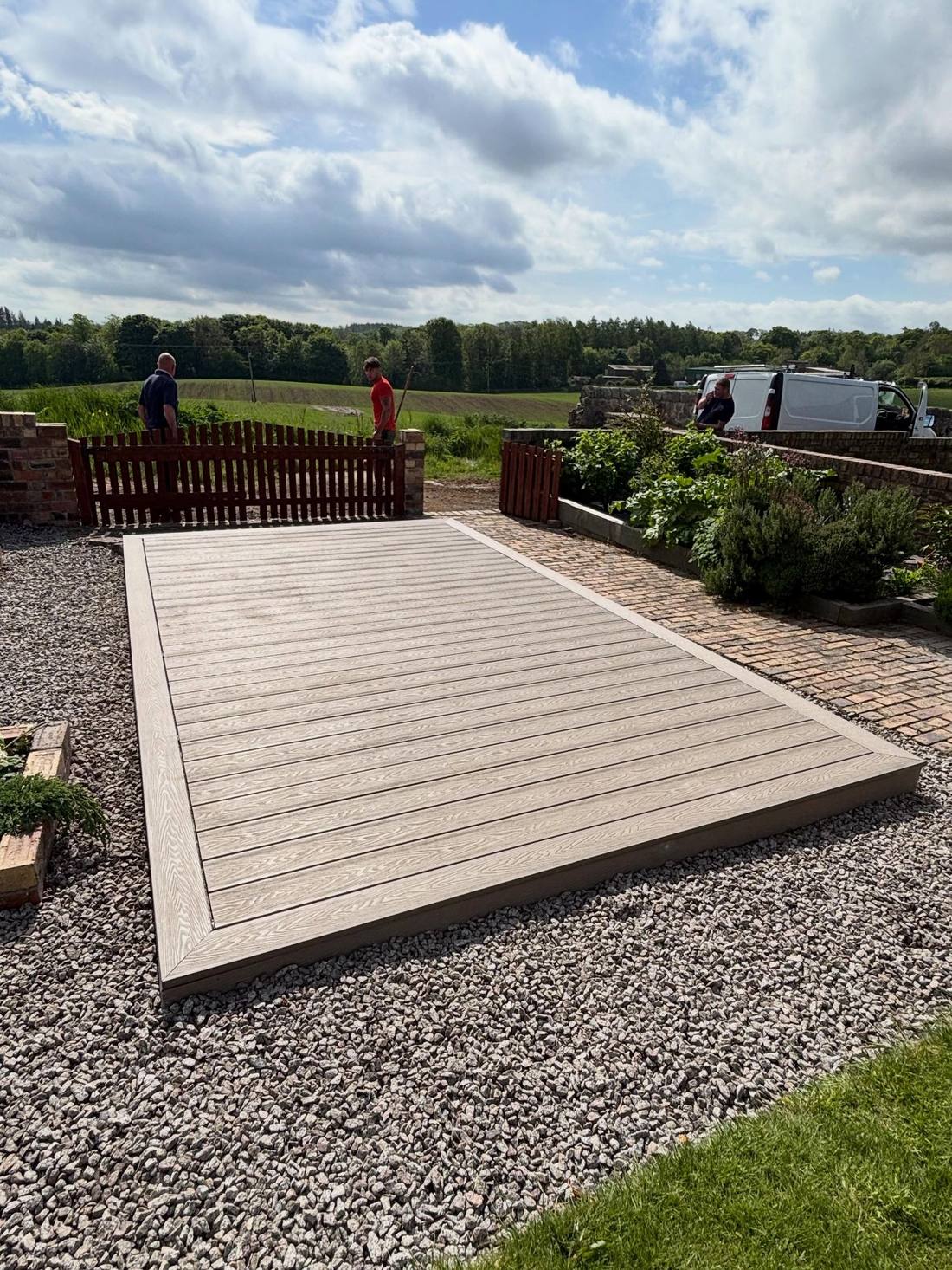 Finished composite decking area with open countryside behind