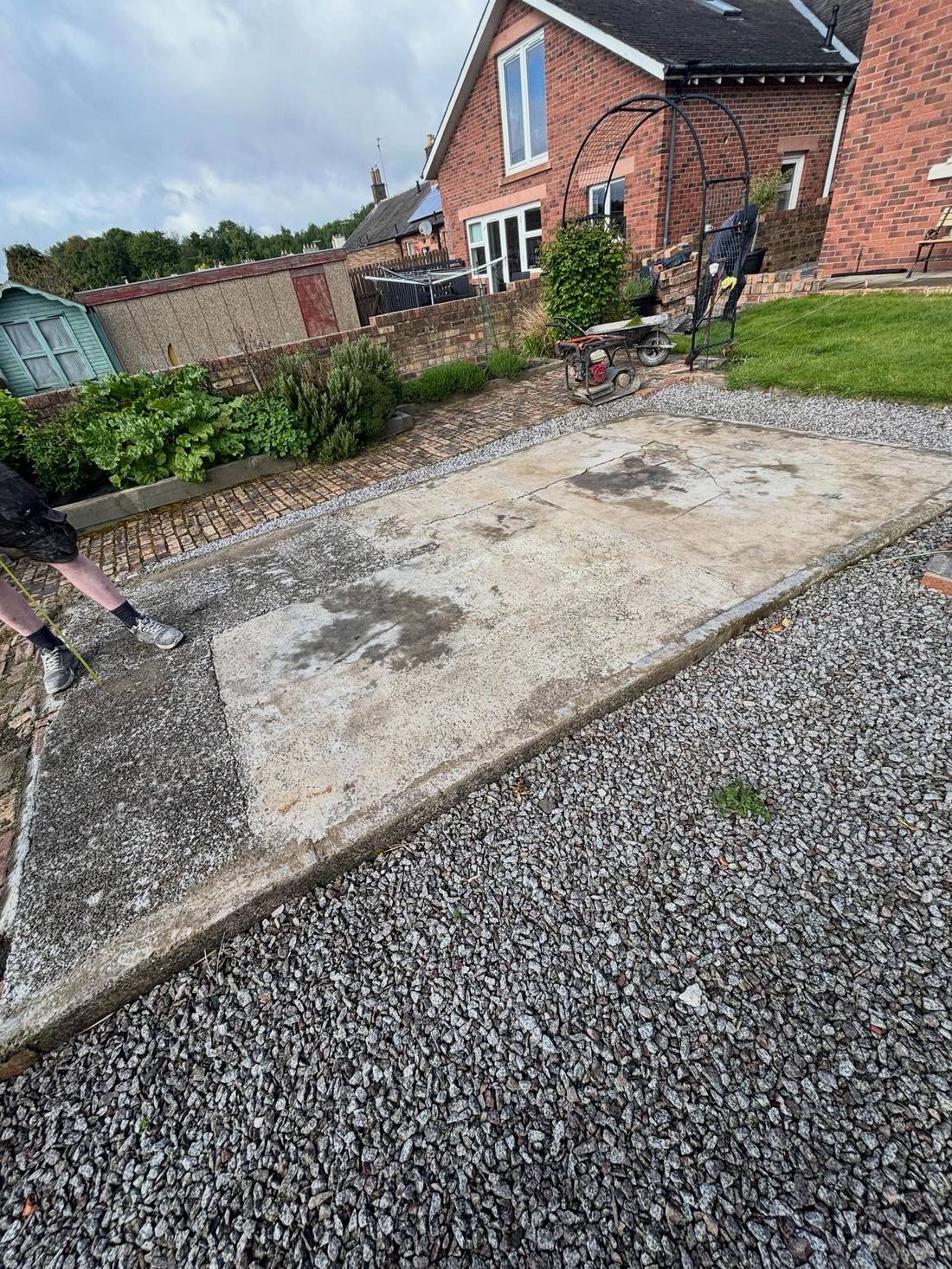 Old cracked concrete slab in the garden before the deck was built