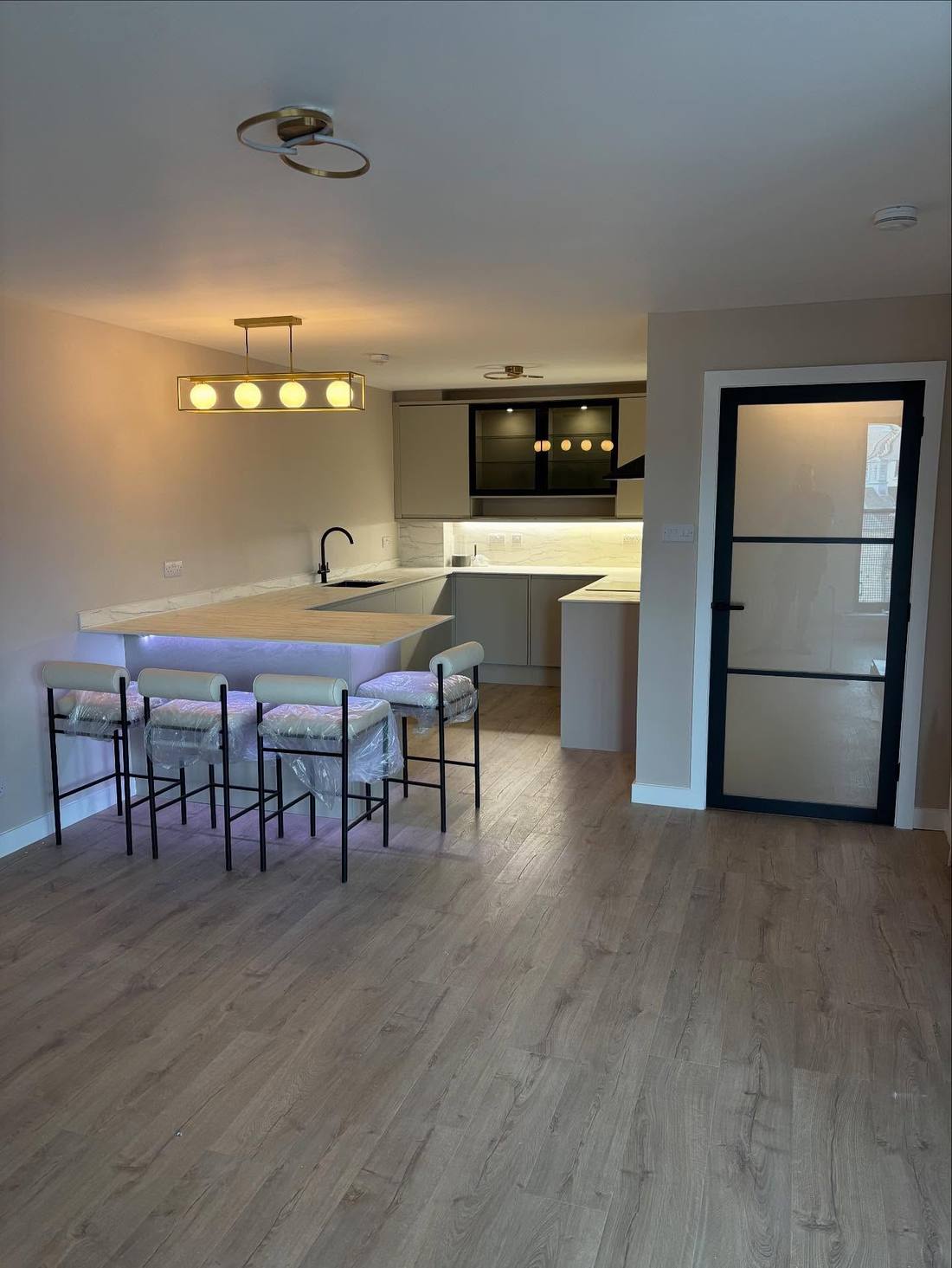 Fitted kitchen with island, breakfast bar and black glazed door, Leith flat renovation